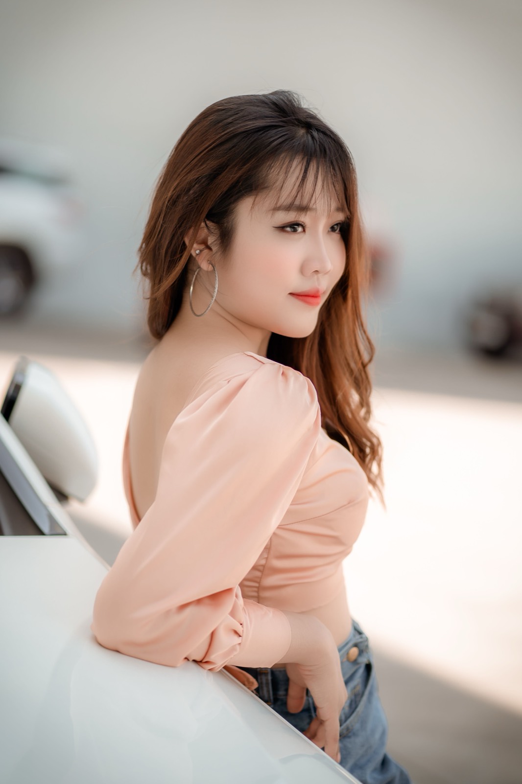 Woman in a peach blouse outdoors