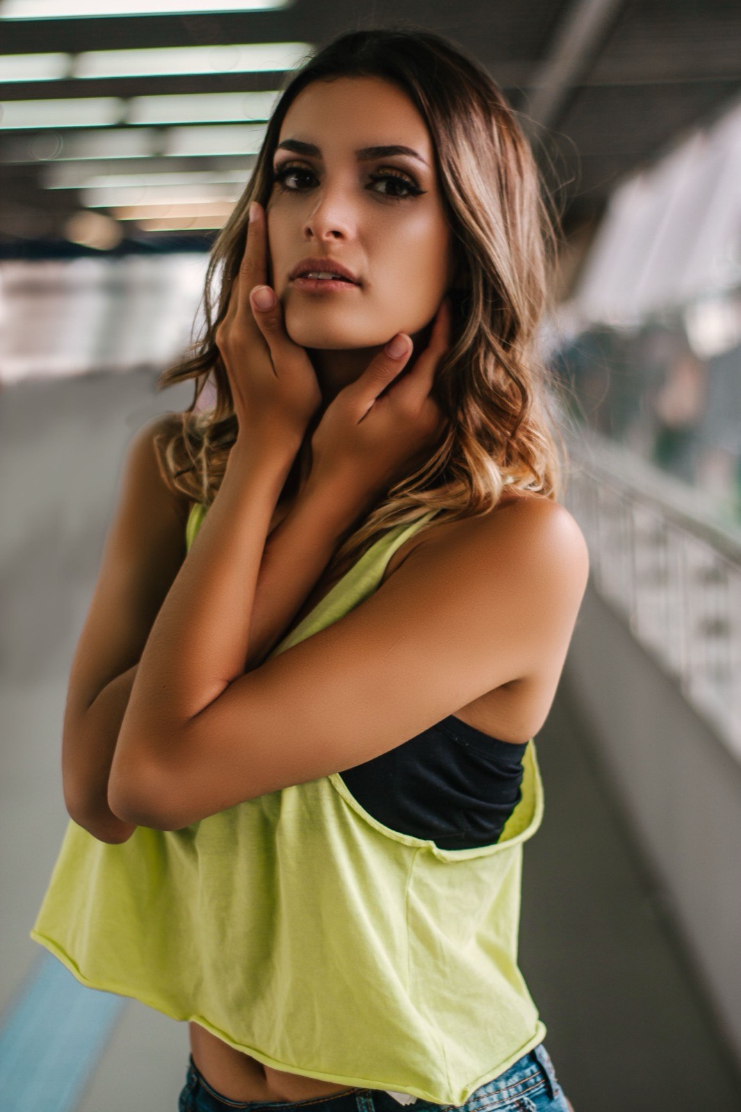 Woman posing in a bright urban transit space
